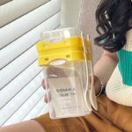 Yellow Portable salad cup with ingredient compartment and fork and spoon - enjoy breakfast on the go